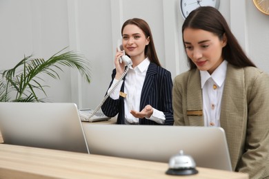 Photo of Beautiful receptionists working at counter in hotel