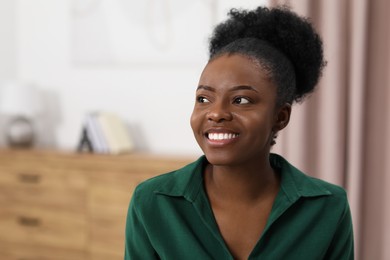 Photo of Portrait of beautiful young woman at home. Space for text