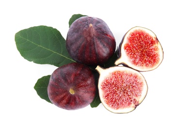 Photo of Fresh juicy purple figs and green leaves on white background, top view