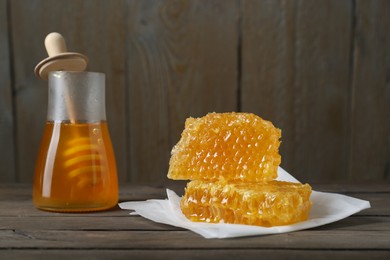 Photo of Natural honeycombs and honey on wooden table