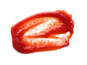 Photo of Smear of tasty ketchup isolated on white, top view