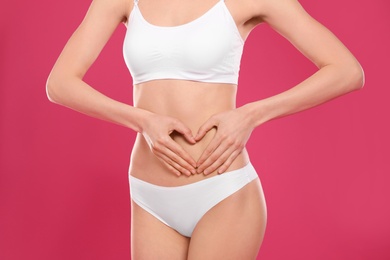 Photo of Slim young woman with smooth skin on color background. Beauty and body care concept