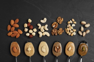 Photo of Tasty nut butters in spoons and raw nuts on dark gray textured table, flat lay. Space for text