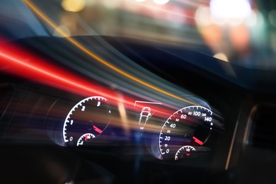 Image of Dashboard with speedometer and tachometer in car, motion blur effect