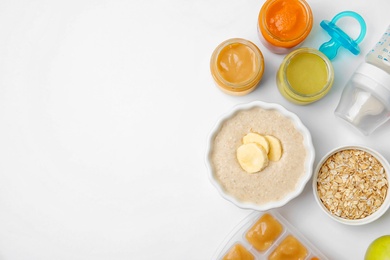 Photo of Flat lay composition with bowl of healthy baby food and space for text on white background