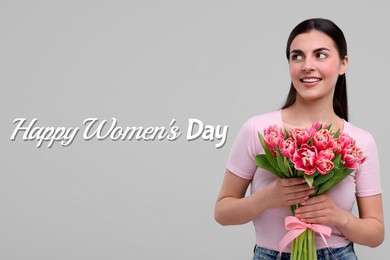 Happy Women's Day - March 8. Attractive lady with bouquet of tulips on light grey background