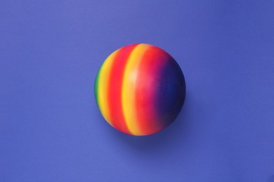 Photo of New bright kids' ball on blue background, top view