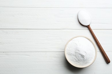 Photo of Baking soda on white wooden table, flat lay. Space for text