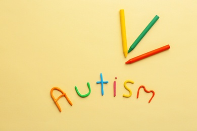 Word "Autism" made of plasticine on color background