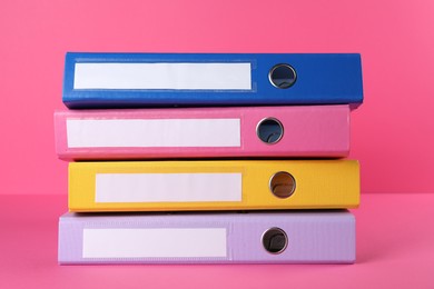 Photo of Stack of office folders on pink background