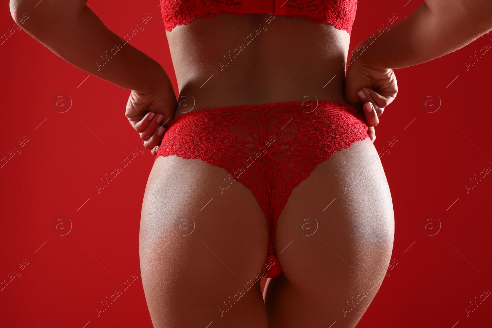 Photo of Woman in sexy panties on red background, closeup
