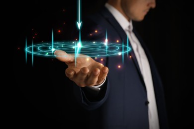 Image of Businessman holding digital target against dark background, closeup