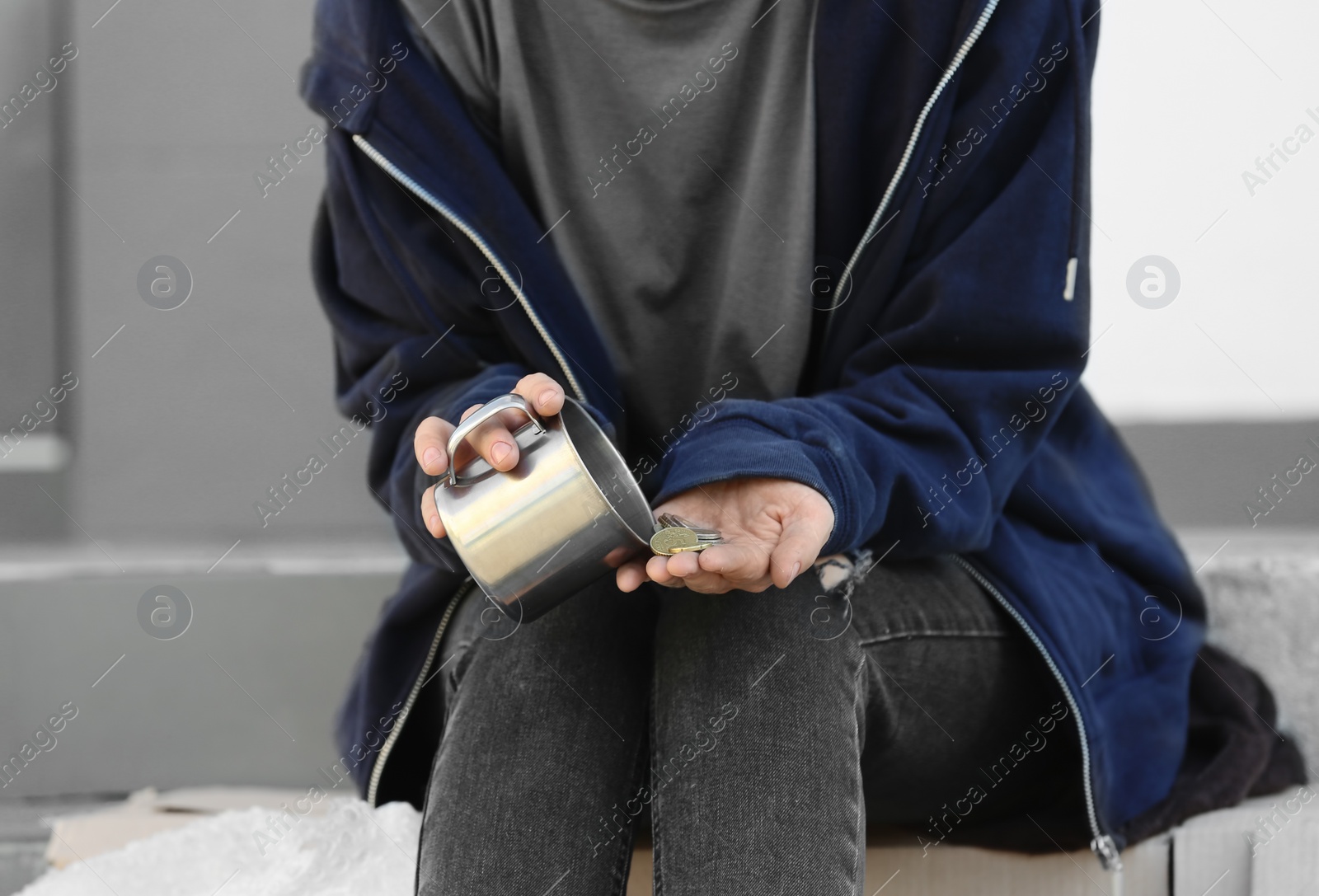 Photo of Poor woman counting coins on city street, closeup
