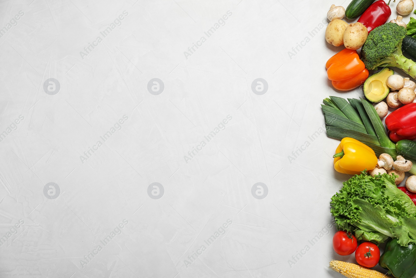 Photo of Fresh vegetables on light grey background, flat lay. Space for text