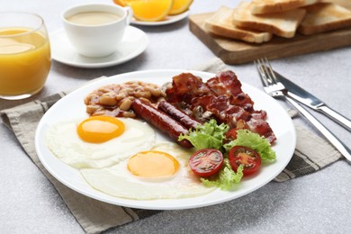 Photo of Delicious breakfast with sunny side up eggs on light table, closeup