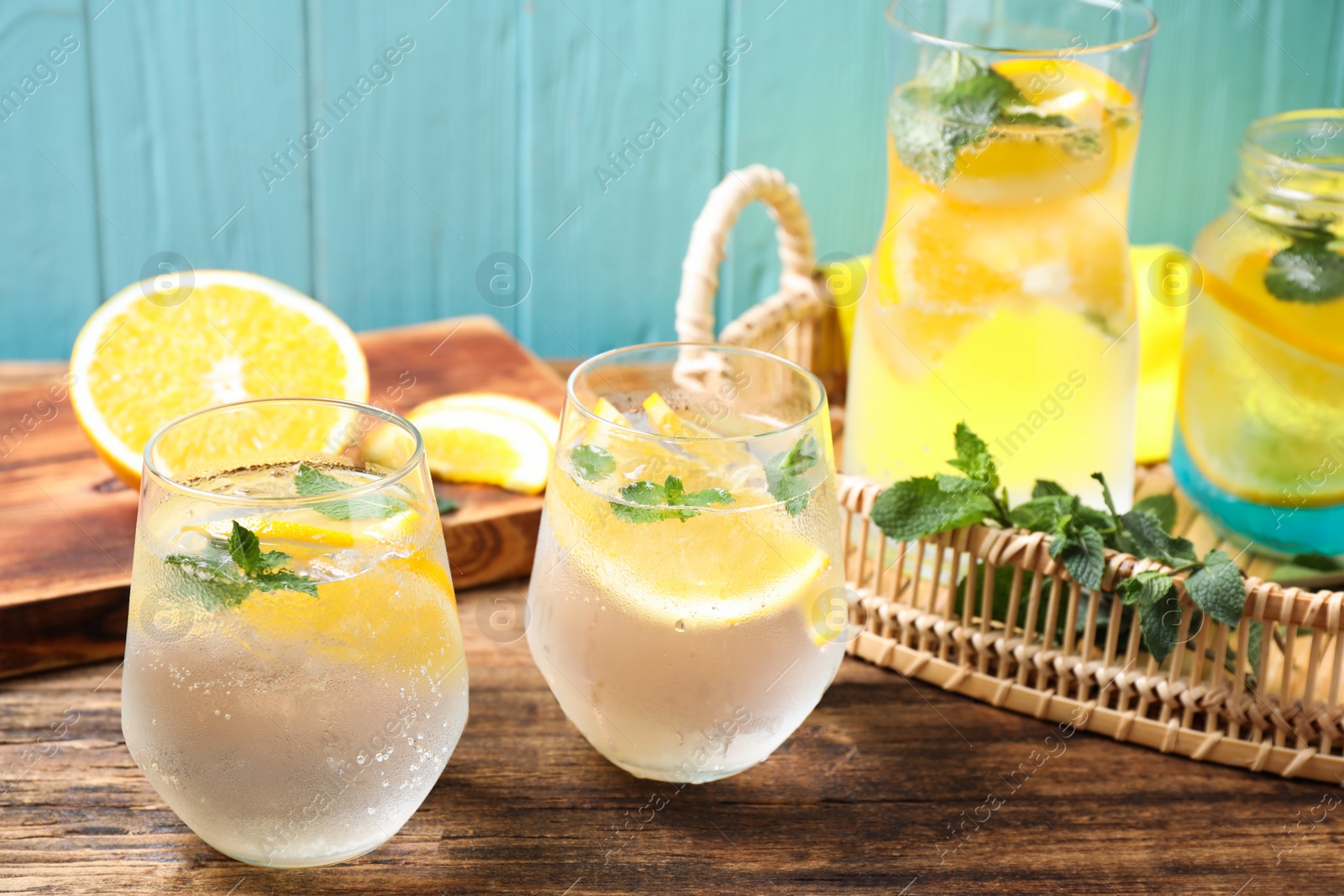 Photo of Delicious refreshing citrus drink on wooden table