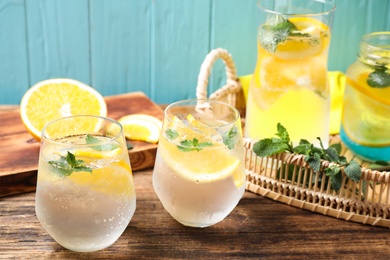 Delicious refreshing citrus drink on wooden table