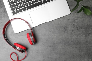 Photo of Flat lay composition with headphones, laptop and space for text on grey background