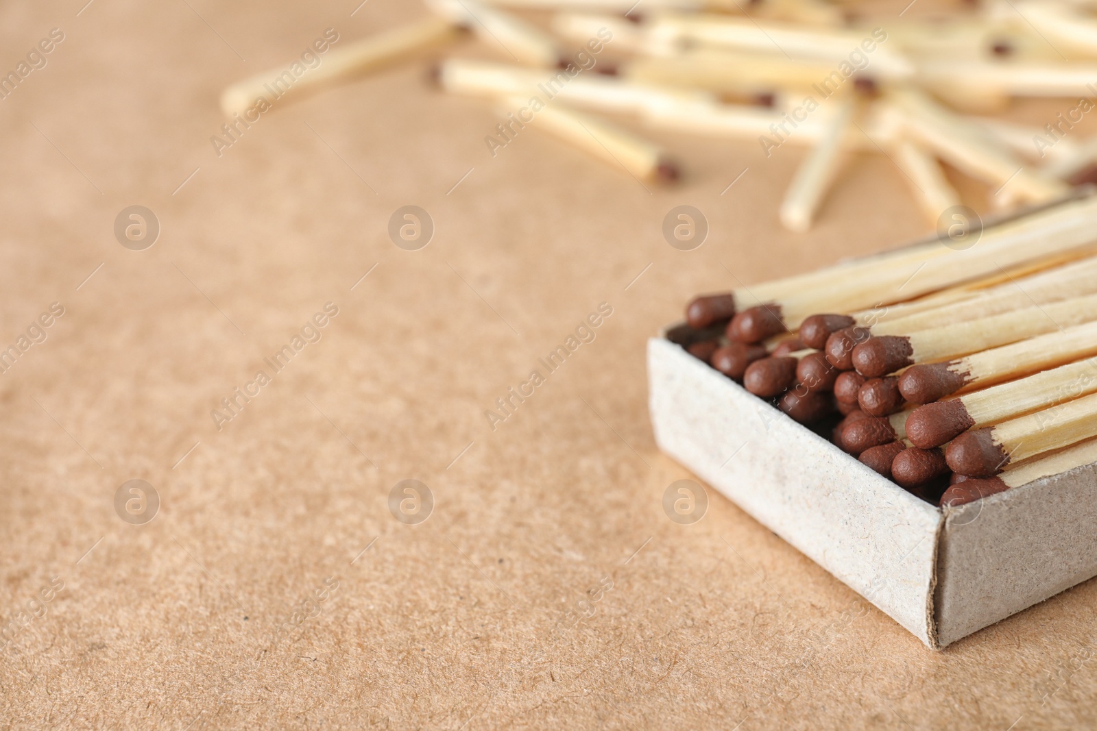 Photo of Open box with matches on craft paper, space for text