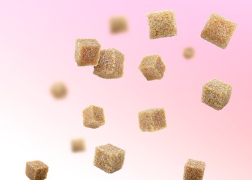 Image of Brown cane sugar cubes falling on color gradient background