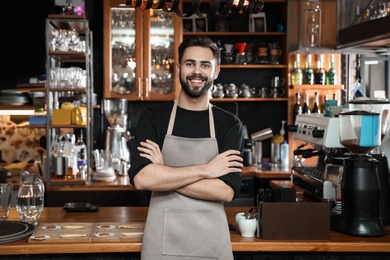 Photo of Portrait of smiling barista in coffee shop