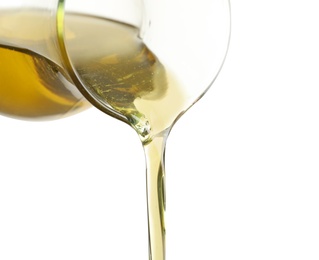 Pouring fresh olive oil on white background