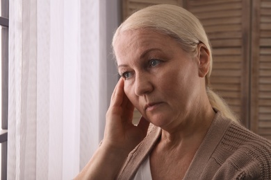 Photo of Mature woman suffering from depression at home