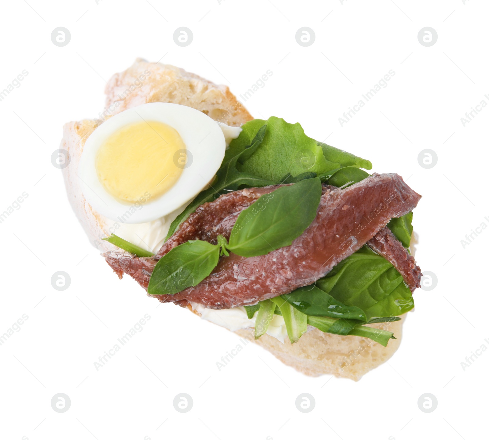 Photo of Delicious bruschetta with anchovies, cream cheese, eggs and greens isolated on white, top view
