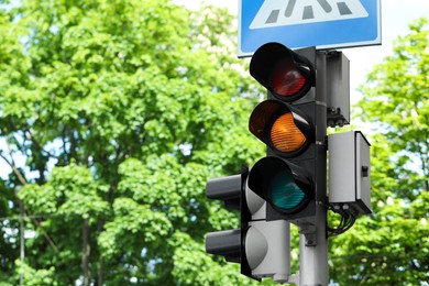 Post with traffic lights and Pedestrian Crossing road sign outdoors