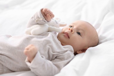 Cute little baby lying on white sheets