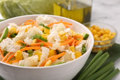 Photo of Tasty salad with Chinese cabbage, carrot, corn and cucumber in bowl on table, closeup