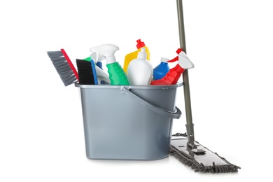 Photo of Mop and plastic bucket with different cleaning supplies on white background