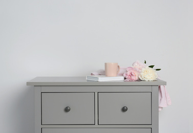 Grey chest of drawers on light background