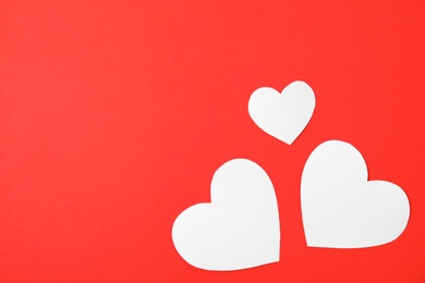 Photo of Small paper hearts on color background, top view