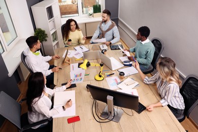 Photo of Team of employees working together in office. Startup project