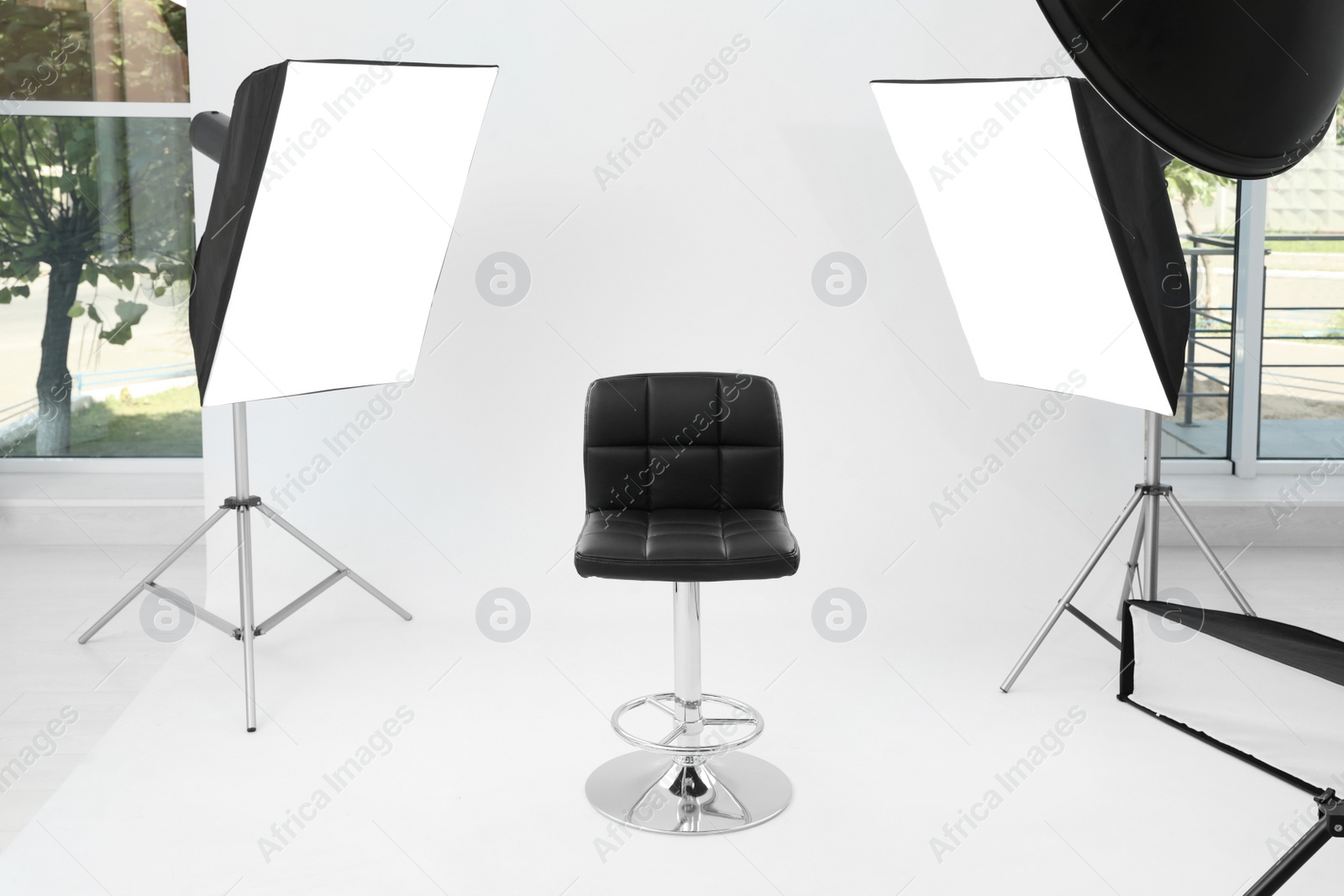 Photo of Interior of modern photo studio with chair and professional equipment