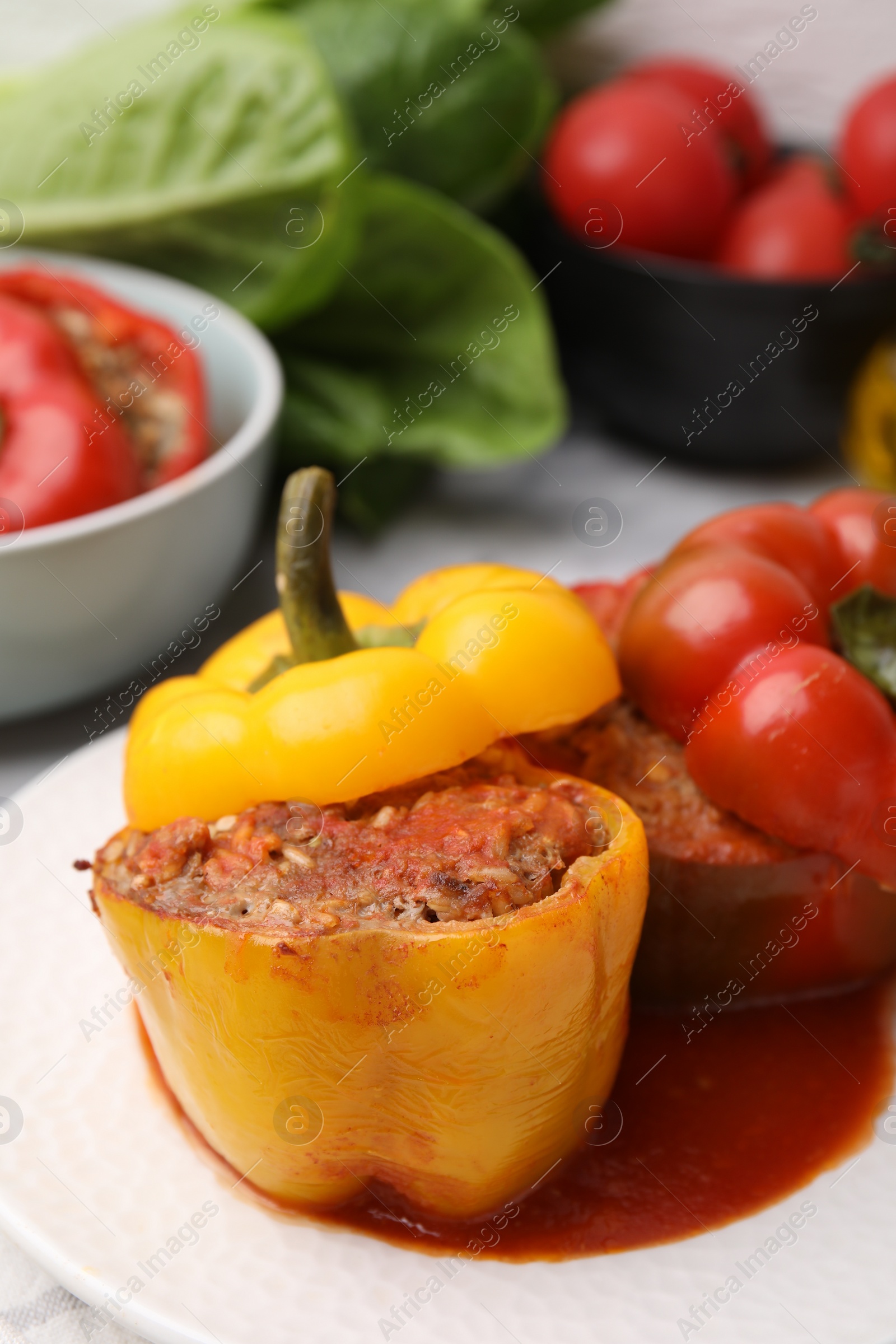 Photo of Delicious stuffed bell peppers served on table, closeup