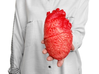 Photo of Woman holding model of heart on white background. Heart attack concept