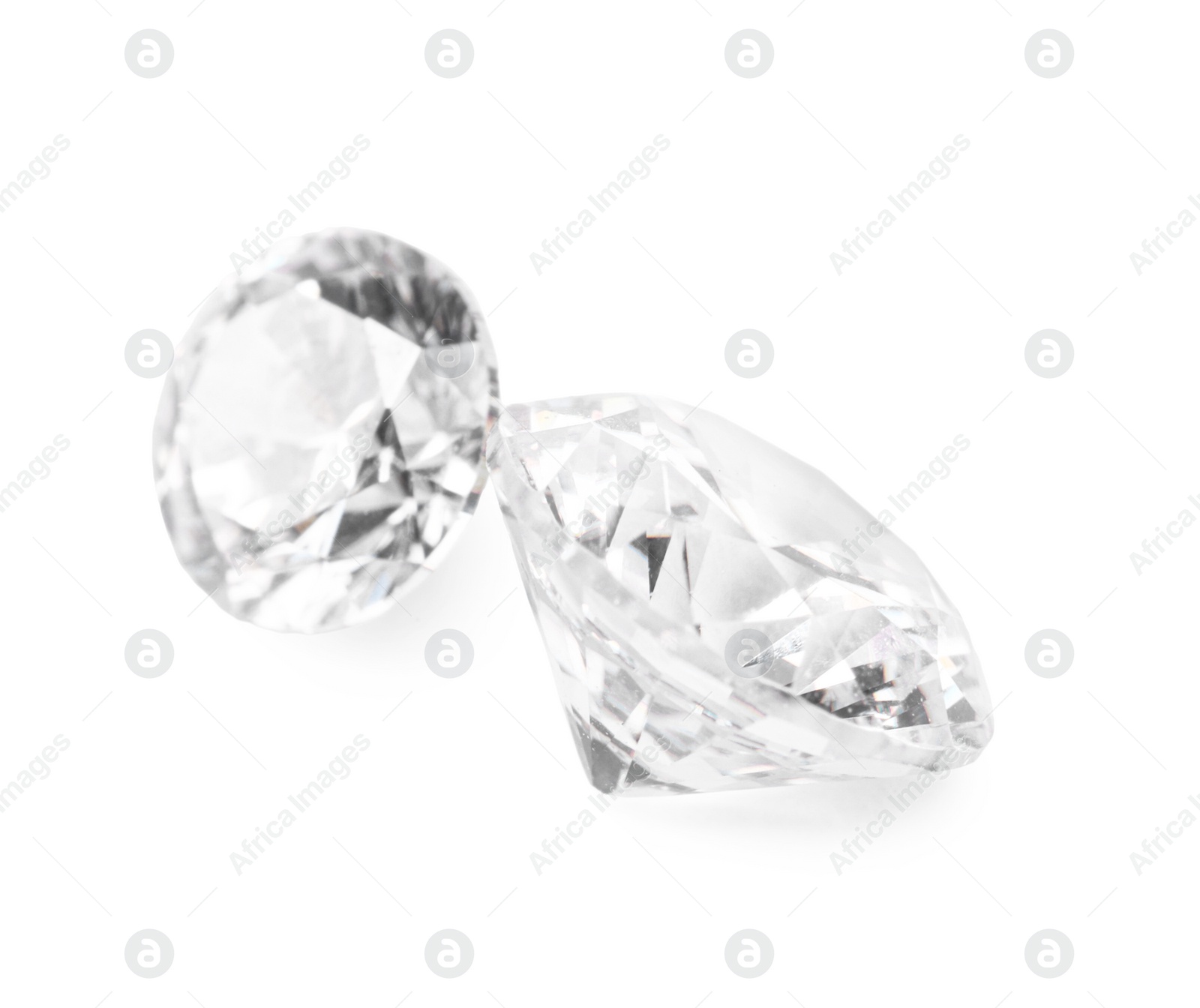 Photo of Two beautiful shiny diamonds isolated on white