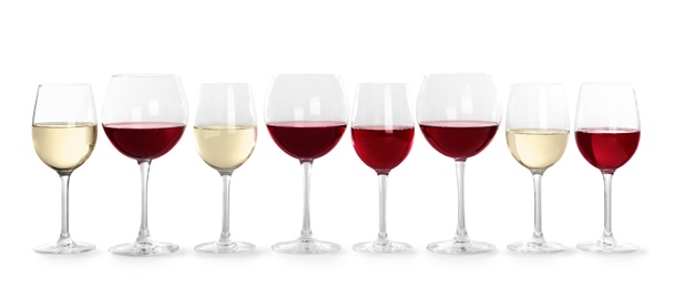 Glasses with different wine on light background