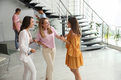 Group of women having conversation in hall