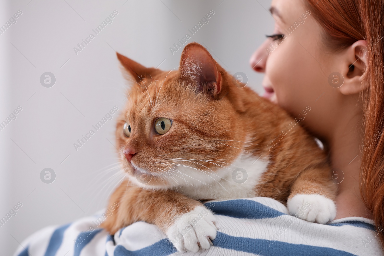 Photo of Woman with her cute cat, closeup view