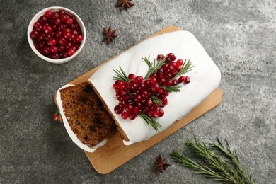 Traditional Christmas cake and ingredients on grey table, flat lay. Classic recipe