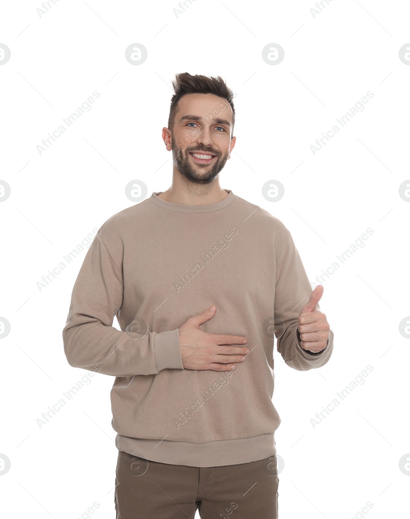 Photo of Happy man touching his belly on white background. Concept of healthy stomach