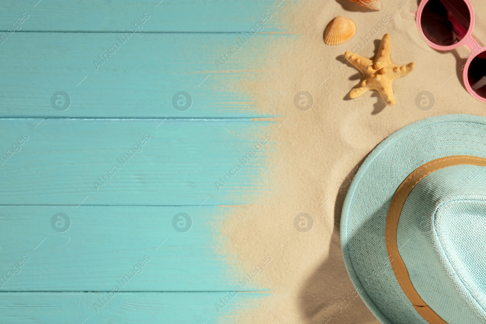 Photo of Flat lay composition with beach objects, sand and space for text on wooden background