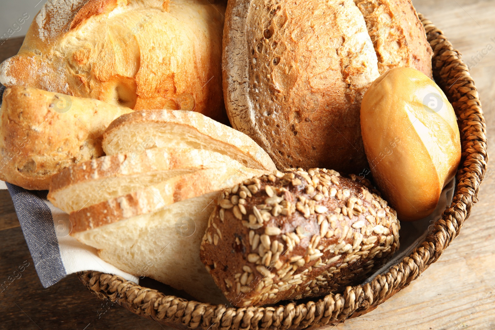 Photo of Basket with fresh bread on table, closeup