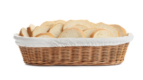 Slices of tasty fresh bread in wicker basket on white background