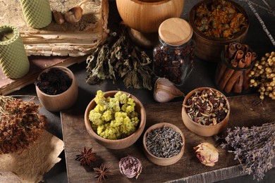Many different dry herbs, flowers and spices on table