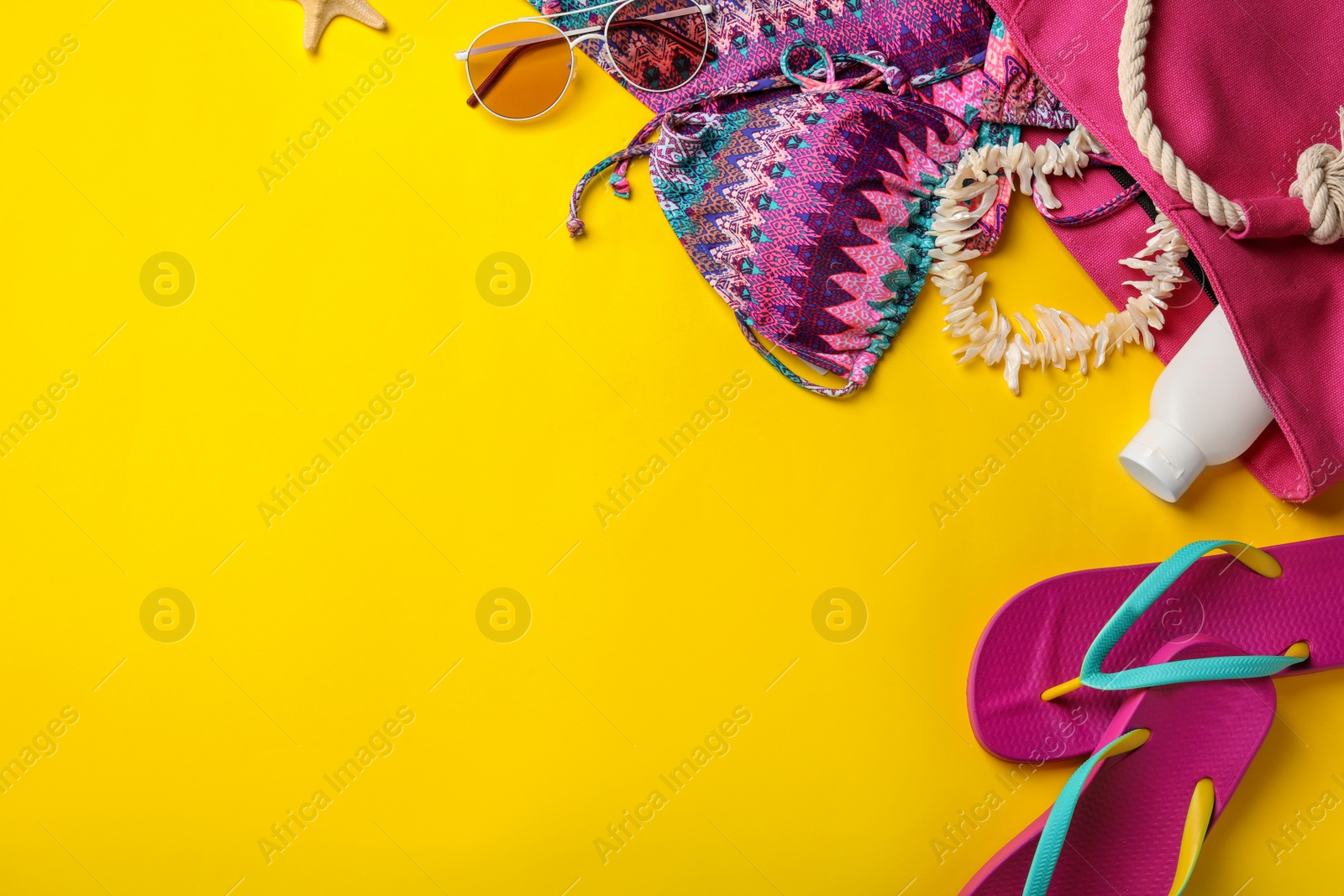 Photo of Flat lay composition with beach accessories on color background. Space for text