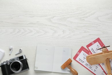 Photo of Flat lay composition with passport, stamp and flight tickets on white wooden table, space for text